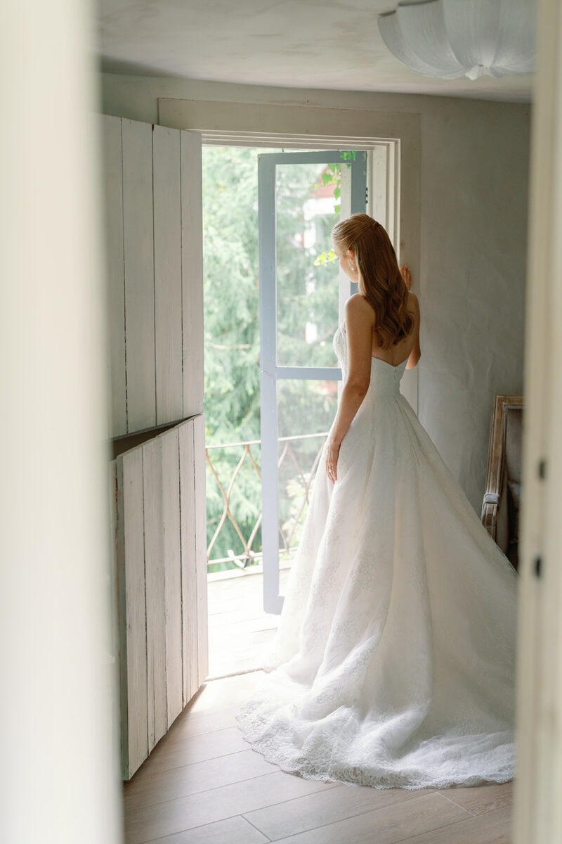 Bride looking out at estate grounds on her wedding day
