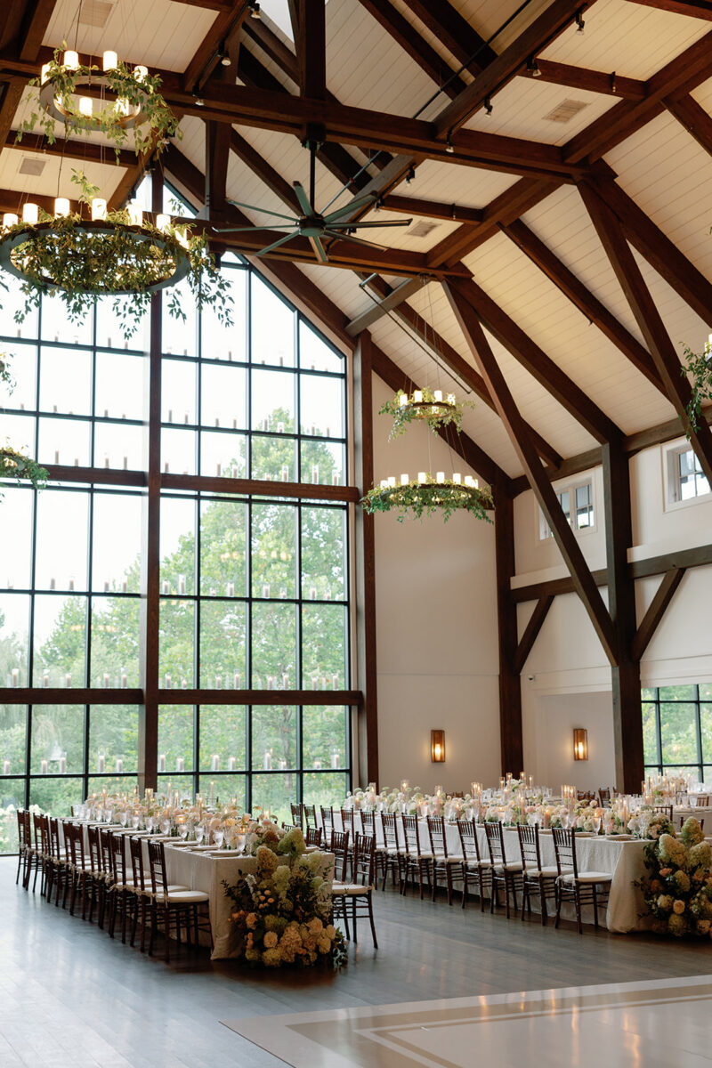 Lush floral runner with desert rose taper candles on farmhouse reception table
