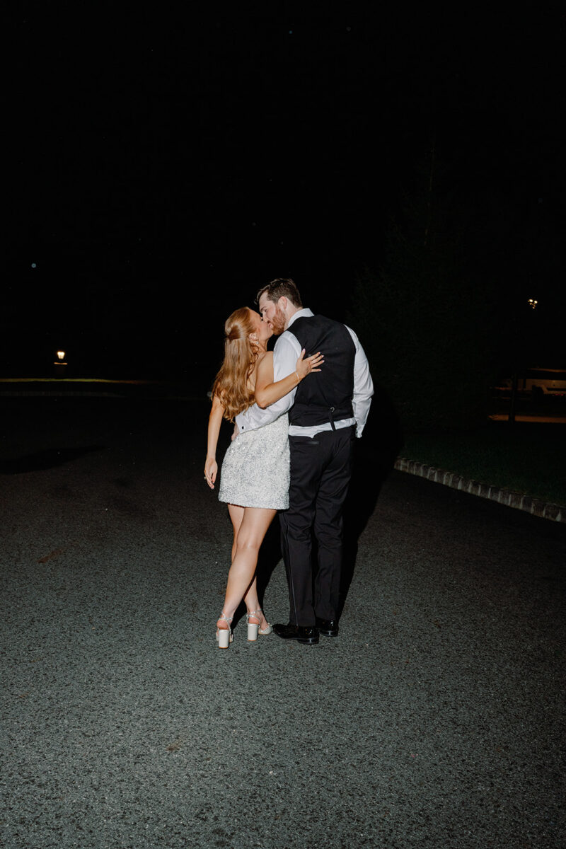 Newlywed couple sneaking away for late night wedding portraits on the grounds at Crossed Keys Estate